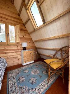 a room with a bed and a chair in a cabin at Aparra Surfcamp Hendaye in Hendaye
