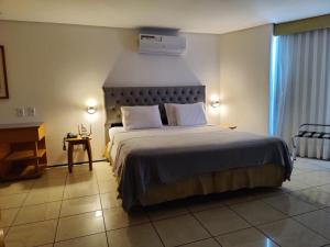 Postel nebo postele na pokoji v ubytování IATE PLAZA HOTEL Calçadão Frente Mar 603 + 24 fotografií