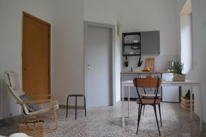 a kitchen with chairs and a table in a room at PortoCielo Yoga e Mare in Nulvi +70 photos