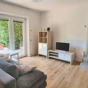 a living room with a couch and a tv at AURELIO in Rijeka