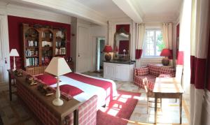 a bedroom with a bed and a living room at Le clos saint Genois in Saint-Genis-Laval