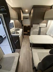 an interior of an rv with two beds and a kitchen at Portugals Infinity - AutoCaravana Luxo in Faro