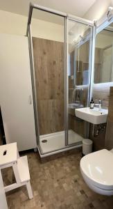 a bathroom with a shower and a toilet and a sink at Burgtiefe Südstrand "Haven Stuuv" in Fehmarn