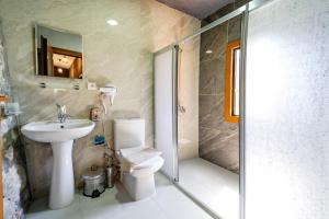a bathroom with a toilet and a sink and a shower at Manzara Bungalov in Fethiye