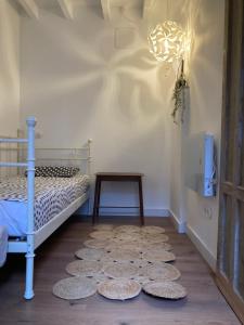 a bedroom with a bed and a table and a rug at Casa Utopia 1 in Grado