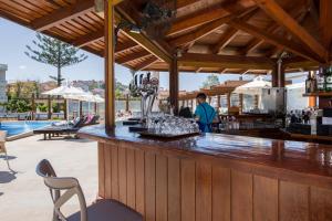a bar at a resort with a pool at Kalyves Beach Hotel in Kalyves