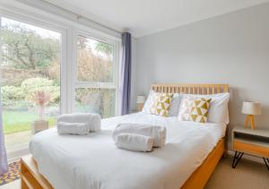 a bedroom with a large white bed with a window at 15 Clifton Park in Cromer