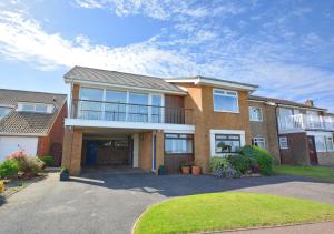 a large brick house with a large driveway at 15 Clifton Park in Cromer