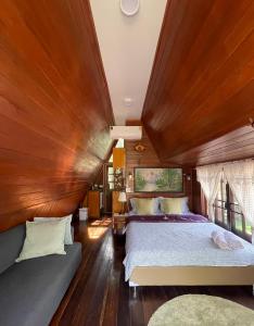 a bedroom with a large bed and a wooden ceiling at PunNa Homestay @ Bangsai in Ban Bang Sai