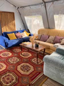昂代Aparra Surfcamp Auberge Hendaye的带沙发的客厅和帐篷内的桌子