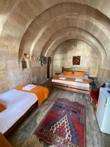 Ένα ή περισσότερα κρεβάτια σε δωμάτιο στο Cappadocia Cave House