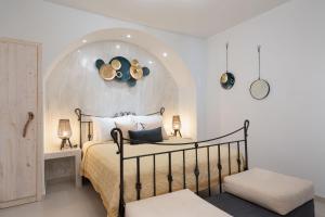a bedroom with a bed with an arch above it at Marilias Apartment in Kamari