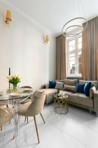a living room with a couch and a table at Old Town Premium by Elite Apartments in Gdańsk