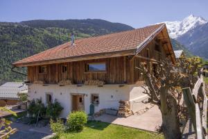 a large wooden house with mountains in the background at Wanderful Life MontBlanc refuge haut de gamme in Saint-Gervais-les-Bains