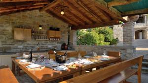 een grote houten tafel in een keuken met een tafel bij Estate with four stone villas and swimming pool in Buzet in Buzet