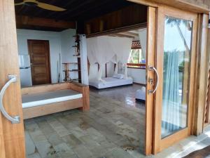 an open door to a room with two beds at Mentawai Balcony in Masokut