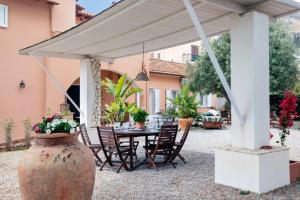a patio with a table and chairs under a pavilion at Villa Marina Sant'Elia in Santa Flavia