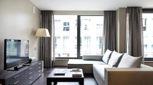 a living room with a couch and a flat screen tv at Allegroitalia San Pietro All'Orto 6 in Milan