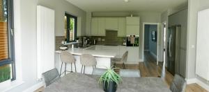 a kitchen with a table and chairs in a kitchen at Entire Modern Home with seaview and parking in Wicklow