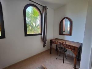 a room with a wooden desk and a window at Apartment Cumbre Vieja Fuerteventura in Corralejo
