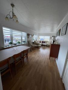 a large living room with a table and chairs at GiljaHome in Sandavágur