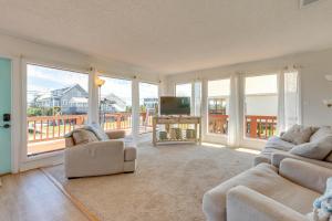 a living room with two couches and a television at Breezy Dauphin Island Vacation Rental with Deck! in Dauphin Island