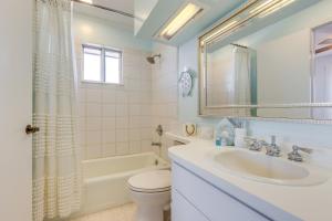 a white bathroom with a sink and a toilet at Breezy Dauphin Island Vacation Rental with Deck! in Dauphin Island +27 photos