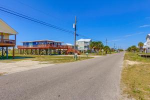 an empty street with houses on the side of the road at Breezy Dauphin Island Vacation Rental with Deck! in Dauphin Island