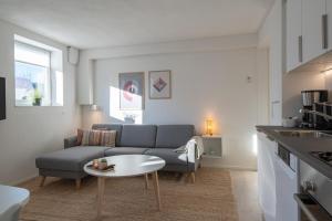 a living room with a couch and a table at Newly renovated 1-Bed Apartment in Aalborg in Aalborg