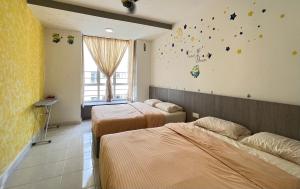 two beds in a room with stars on the wall at FuYoke Emerald Avenue @ Brinchang in Cameron Highlands