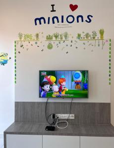 a tv screen with a maroons sign on a wall at FuYoke Emerald Avenue @ Brinchang in Cameron Highlands