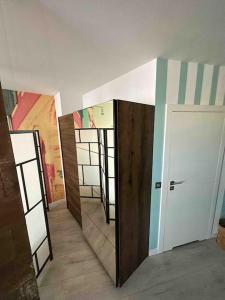 a room with a mirror and a hallway with doors at Przestronna i jasna kawalerka z balkonem in Wrocław