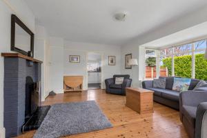 a living room with a couch and a fireplace at Pass the Keys Little Haven A stunning Bungalow in Minnis Bay in Birchington