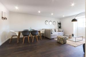 a living room with a table and chairs and a couch at Benfica Apartments III by Homing in Lisbon