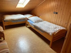 Habitación pequeña con 2 camas en una cabaña en Ferienwohnung zum Nürburgring en Münk