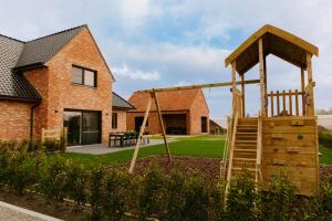 a playground in the backyard of a house at Luxe Vakantiewoning De Veldhoek in Wingene