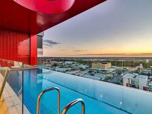 a swimming pool with a view of a city at Prestige 2bd Apartment Gym/Pool in Adelaide