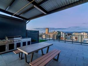 a patio with a table and a stove and a view at Prestige 2bd Apartment Gym/Pool in Adelaide