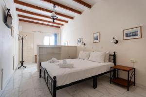 a bedroom with a large bed in a room at Villa Kalomira in Spetses