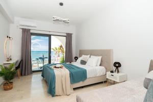 a bedroom with a bed and a view of the ocean at Villa Milano in Laganas