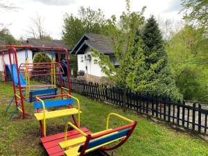 a playground with colorful play equipment in a yard at Хотел Света гора in Oreshak