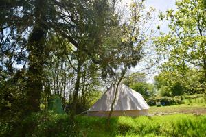 a tent in the middle of a field with trees at L'Angeberdière - Tente nature au calme in Saint-Mars-sur-la-Futaie