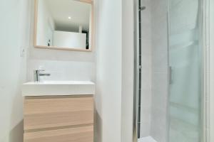 une salle de bain avec lavabo et douche dans l'établissement Les Belles Noës, à Saint-Briac-sur-Mer 6 autres photos