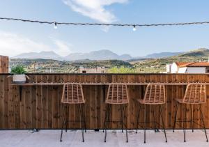 a group of chairs sitting at a bar on a fence at Hospitium Crete in Moírai