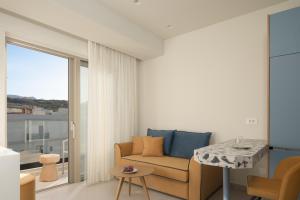 a living room with a couch and a table at Ostria Deluxe Suite Studio in Rethymno Town