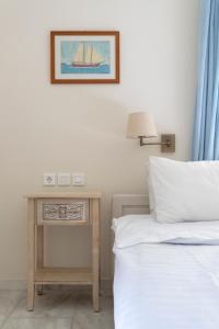 a bedroom with a bed and a nightstand next to a bed sidx sidx sidx at Villa Kalomira in Spetses