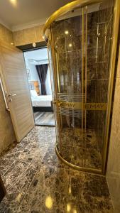ein Bad mit einer Dusche und ein Zimmer mit einem Bett in der Unterkunft EMAY OTEL in Trabzon