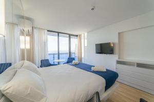 a bedroom with a large bed and a large window at Orbi City Hotel Group Batumi in Batumi