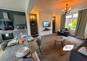 a living room with a dining table and a kitchen at Luke Stays - Chilside Road in Felling