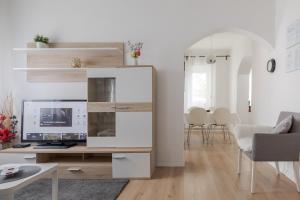 a living room with a desk with a computer on it at Lisinski apartment with private parking in Zagreb